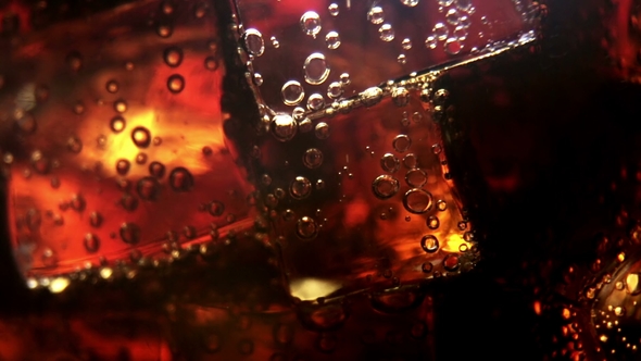 Cola Background. Pouring Cola with Ice and Bubbles in Glass