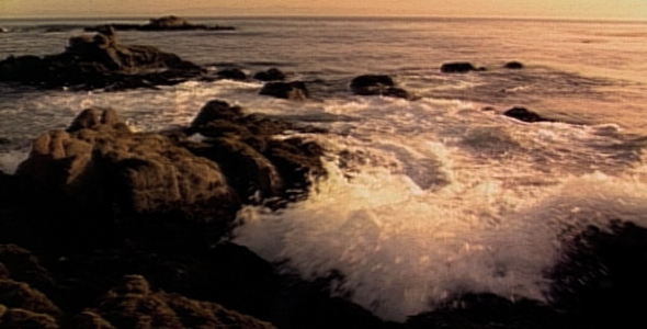Ocean Waves crash into Rocks at Sunrise