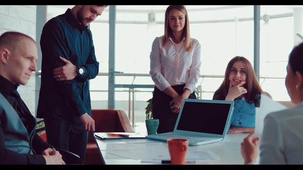 Companions and the Head of the Company Study Graphs and Diagrams on Sheets on the Office Table at a alt