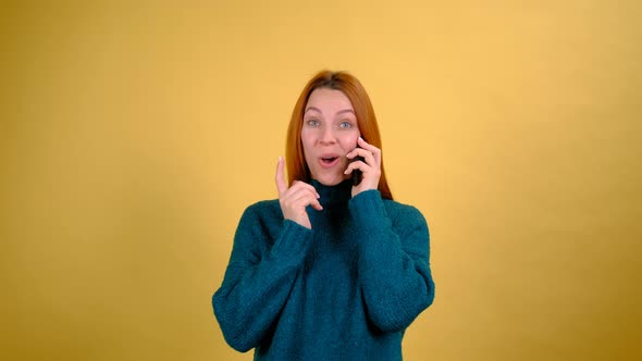 Young Red Hair Woman in Green Sweater Posing Isolated on Yellow Color Background Studio