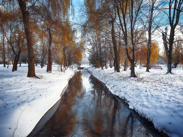 Scenic view of the river and trees with first snow - Stock Photo - Images