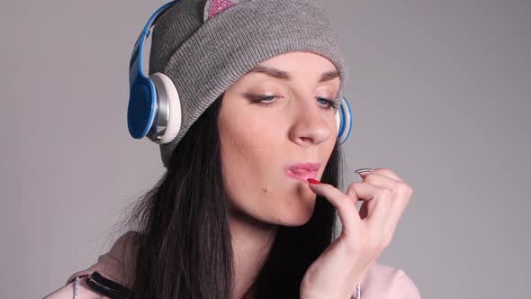 Young Caucasian Woman with Tail Eating Piece of Pizza