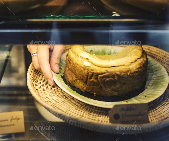 Woman getting cake out of the display fridge Stock Photo by Rawpixel