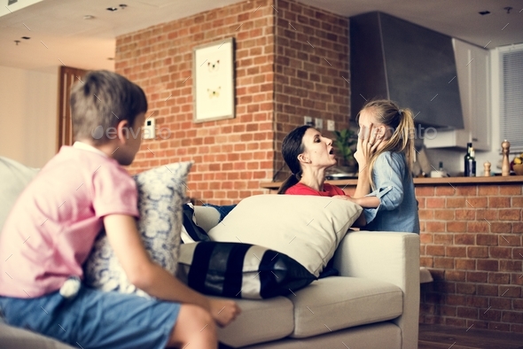 Mother consoling daughter and son sitting on the couch Stock Photo by Rawpixel