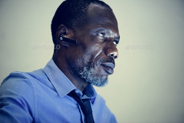 African ethnicity businessman with bluetooth earphone