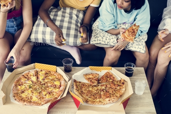 Diverse women sitting on the couch eating pizza together Stock Photo by Rawpixel