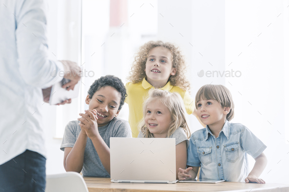 Smiling children during programming classes Stock Photo by bialasiewicz