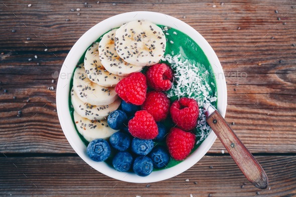 Smoothie bowl with spirulina powder, banana, raspberries and blueberries, chia seeds