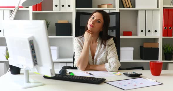 Businesswoman Sitting in Office-chair and Looking Away