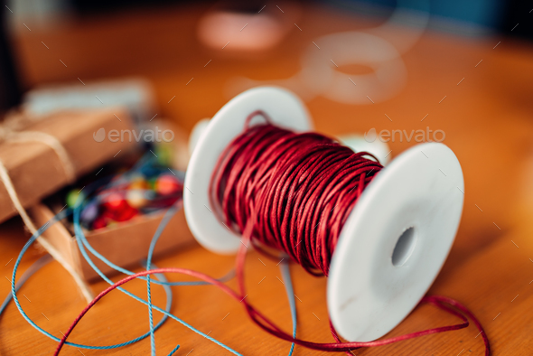 Needlework, coil with red decorative rope, closeup - Stock Photo - Images