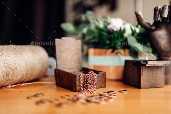 Needlework, metal rings and wooden box on table - Stock Photo - Images