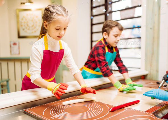Little girl and boy learn to make caramel - Stock Photo - Images
