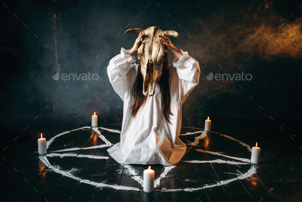 Woman holds skull of the animal in hand, occultism - Stock Photo - Images