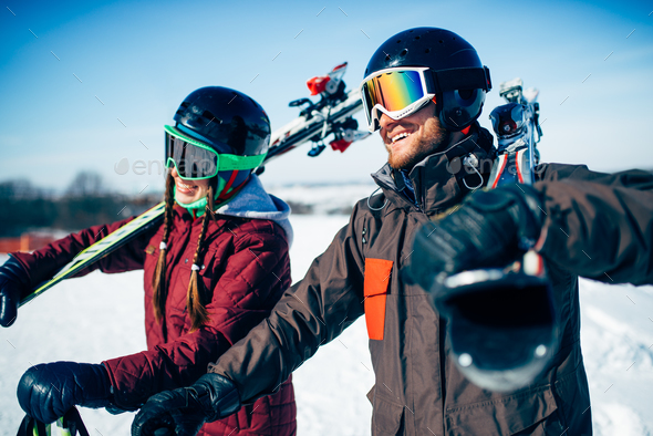 Male and female skiers poses with skis and poles - Stock Photo - Images