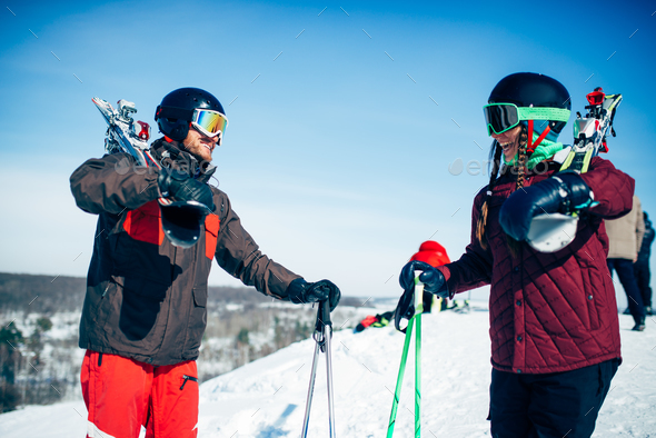 Male and female skiers poses with skis and poles - Stock Photo - Images