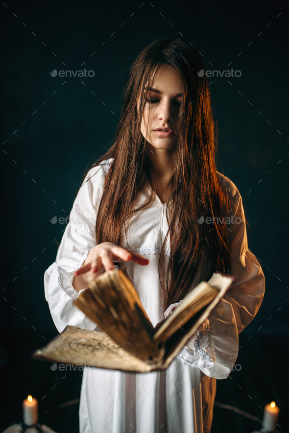 Woman sitting in the center of pentagram circle - Stock Photo - Images