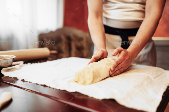 Chef prepares classic apple strudel for baking - Stock Photo - Images