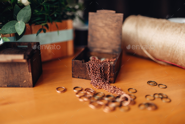 Needlework, metal rings and wooden box on table - Stock Photo - Images