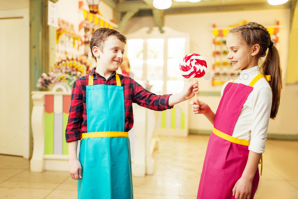 Boy gives handmade lollipop to his girlfriend - Stock Photo - Images