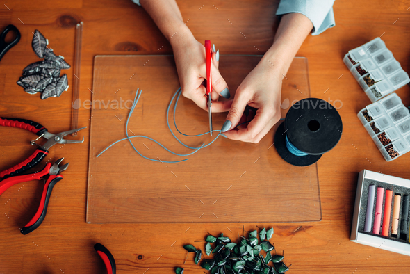 Female hands with pliers, top view, needlework - Stock Photo - Images