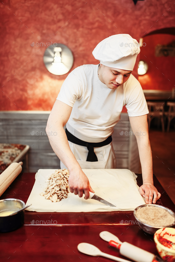Male chef prepares apple strudel - Stock Photo - Images
