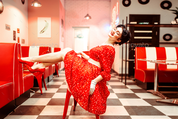 Sexy pin up girl with makeup posing in retro cafe - Stock Photo - Images