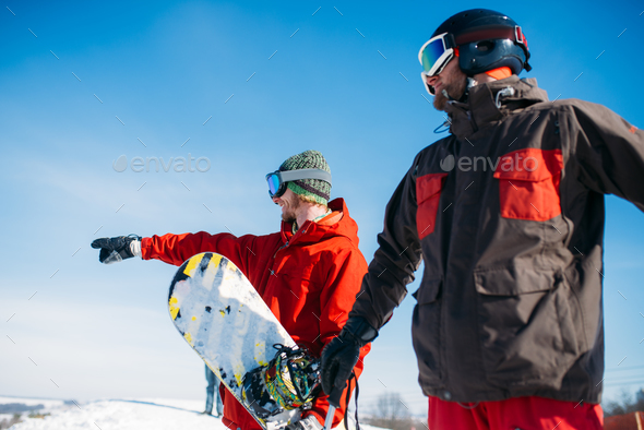 Snowboarder and skier poses on the top of mountain - Stock Photo - Images