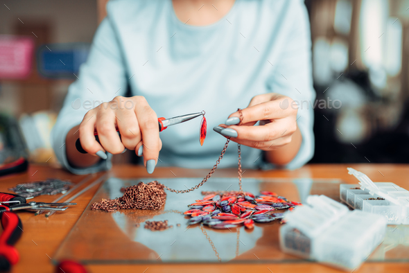 Female person holds pliers, bijouterie making Stock Photo by NomadSoul1