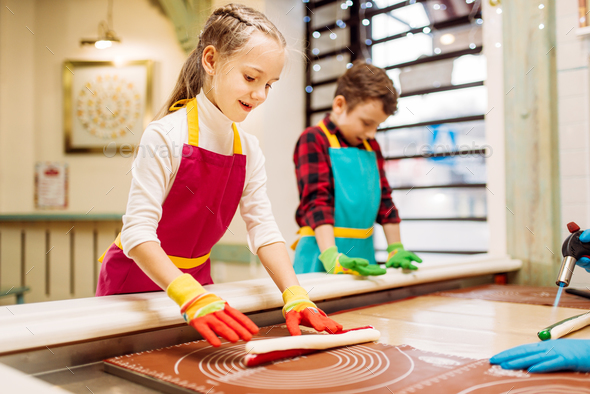 Little girl and boy learn to make caramel - Stock Photo - Images