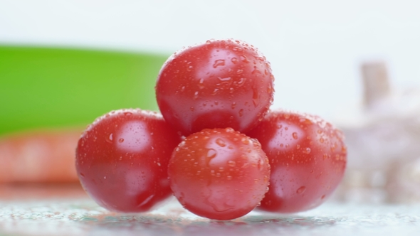 Detail of Ripe Tomatoes Being Sprayed with Water alt