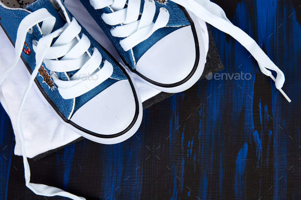 Flat lay of female sneakers shoes and tee - Stock Photo - Images