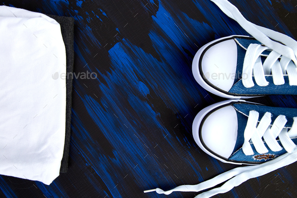 Flat lay of female sneakers shoes and tee - Stock Photo - Images
