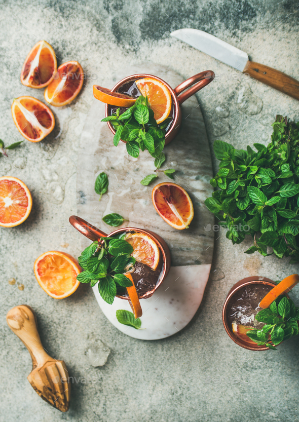 Blood orange Moscow mule alcohol cocktails in mugs, top view - Stock Photo - Images
