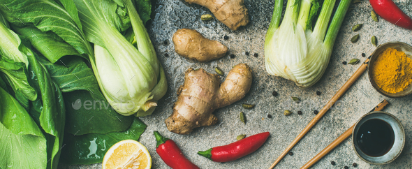 Flat-lay of Asian cuisine ingredients over concrete background, wide composition - Stock Photo - Images