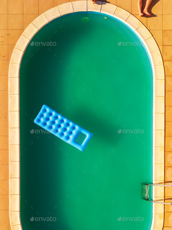 Aerial view of people relaxing by swimming pool - Stock Photo - Images