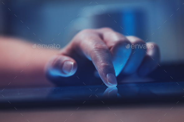 Woman reading online news on digital tablet - Stock Photo - Images