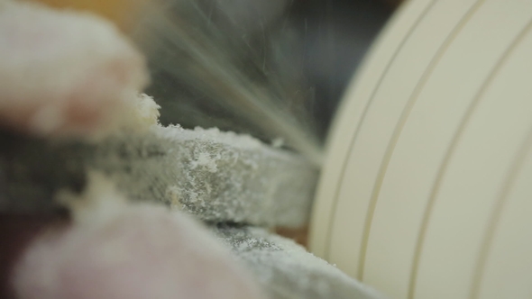 Man Working on Wood Lathe Using a Skew Chisel alt