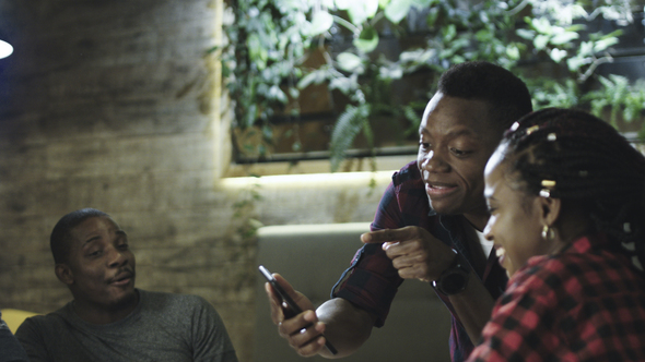 Black Cheerful Friends Enjoying Meeting in Cafe alt