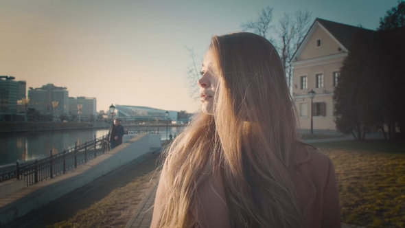 A Girl with Beautiful Long Hair Goes Straight To the Camera. Strolls Down the Street