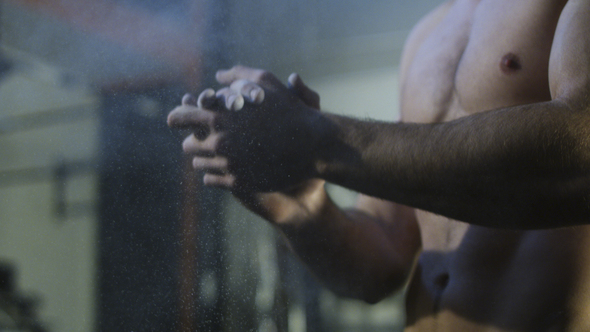 Sportsman Applying Chalk Powder Before Exercise alt
