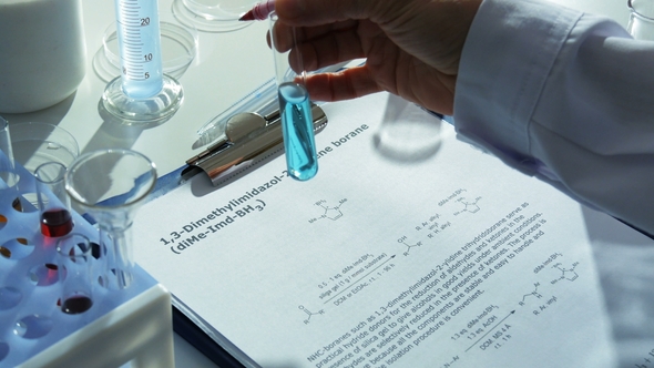 Chemistry Lab - Researcher Writes Results of His Experiment Down