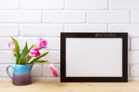 Black brown landscape frame mockup with pink tulip in purple bl - Stock Photo - Images