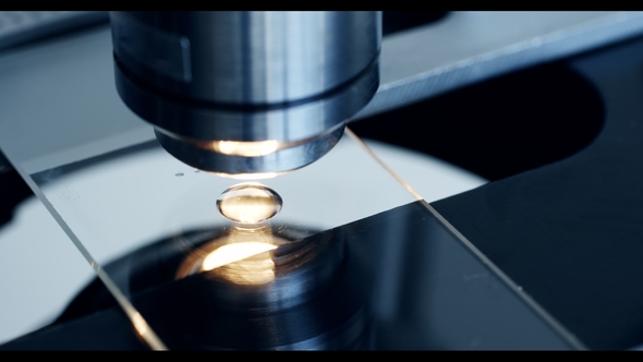 Examining of Test Sample Under the Microscope in Laboratory alt