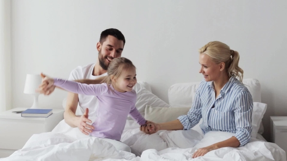 Happy Family Having Fun in Bed at Home 9 alt