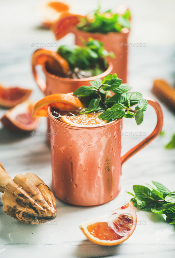 Blood orange Moscow mule alcohol cocktails in copper mugs - Stock Photo - Images