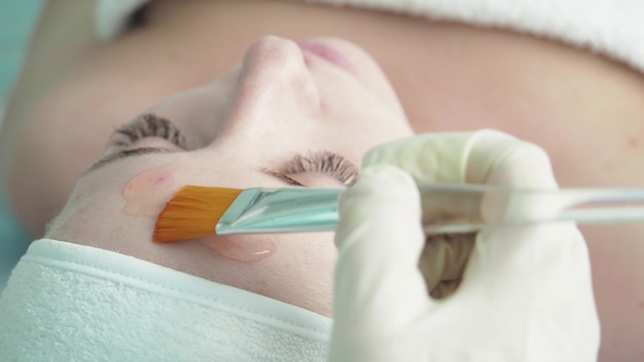 The Cosmetologist Puts a Brush on the Face with a Brush