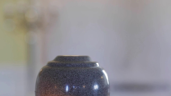 Funerary Urn and Candles on Table Burning Indoors 14 alt