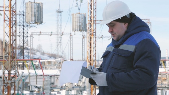 Engineer With Tablet at Electric Power Station