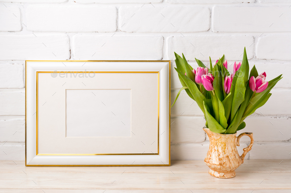 Gold decorated landscape frame mockup with bright pink tulips in - Stock Photo - Images
