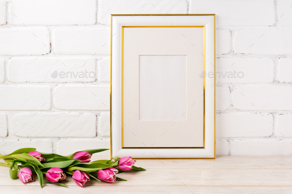 Gold decorated frame mockup with magenta tulips bouquet - Stock Photo - Images